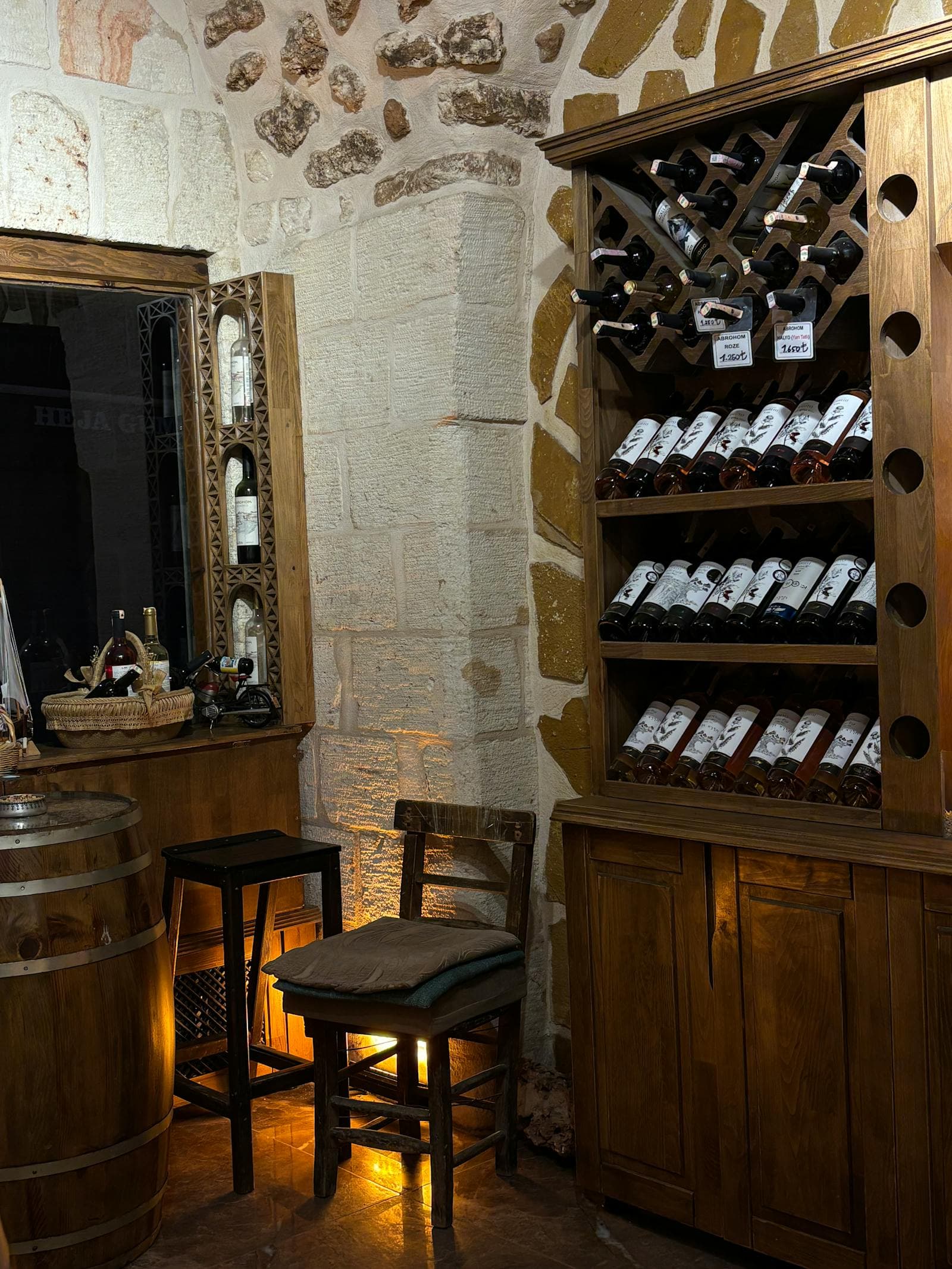 Stone-walled underground wine cellar construction with arched ceiling and traditional bottle storage
